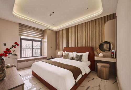 a bedroom with a large bed and a window at Luckin Hotel Lê Đức Thọ by Urban B in Ho Chi Minh City