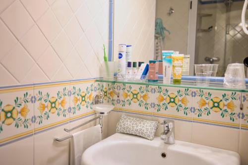 a bathroom with a sink and a mirror at Amalfi Hotel centro storico in Amalfi