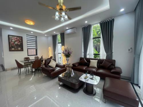 a living room with a couch and a table at Van Khe Cozy Villa in Hà Ðông