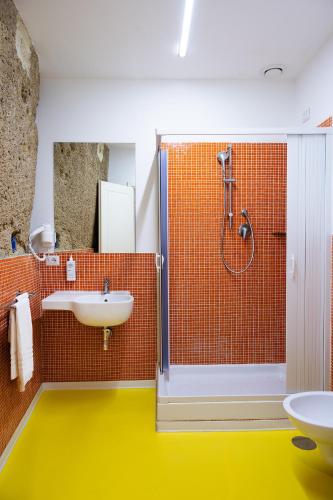 a bathroom with a shower and a sink and a toilet at Correra 241 Lifestyle Hotel in Naples