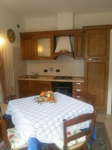 a kitchen with a table with a flower arrangement on it at Hotel Bruna in Lizzano in Belvedere