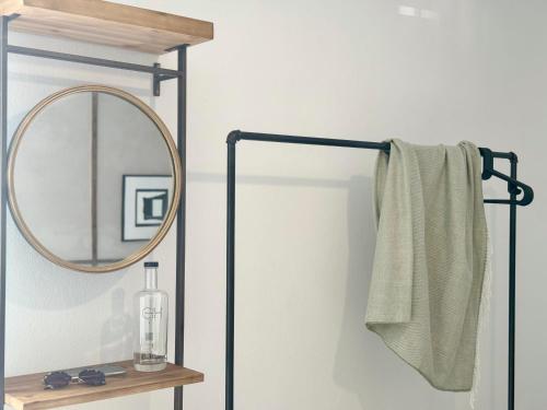 a bathroom with a mirror and a towel rack at Canaryislandshost I Marino in Famara