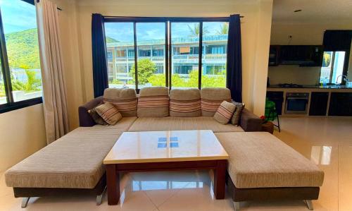 a living room with a couch and a table at Viking House Villa Deluxe in Ko Tao