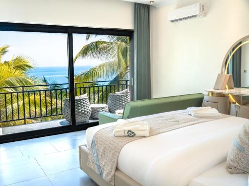 a bedroom with a bed and a view of the ocean at Apsara Resort Koh Rong in Koh Rong Island