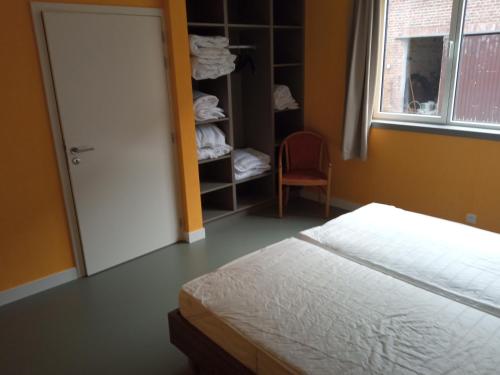 a bedroom with a bed and a closet at Sophia-Elvira in Diksmuide