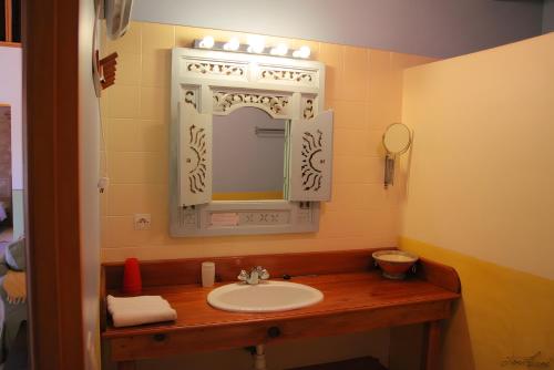a bathroom with a sink and a mirror at Domaine du Roujos - Gite Ocre in Beaumont-de-Lomagne