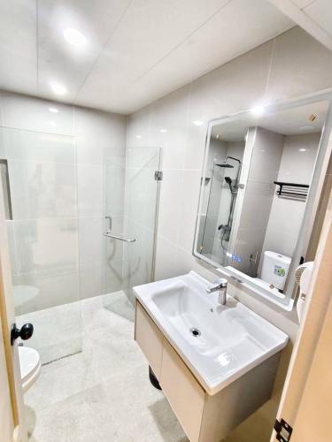 a bathroom with a sink and a shower and a mirror at 3-bedroom apartment, Patong, Palm Spring 602 in Patong Beach