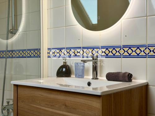a bathroom with a sink and a mirror at GC - Au Gré Du Vent in Wissant