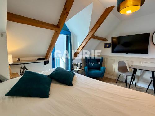 a bedroom with a bed with a tv and a table at GC - Au Gré Du Vent in Wissant
