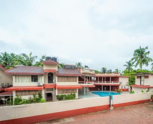 a view of a house with a swimming pool at Treebo Sunshine Beach Resort with Swimming Pool in Calangute