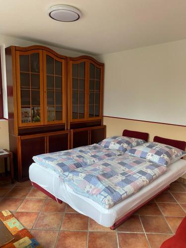 a bedroom with a bed and wooden cabinets at Wassermühle in Rheine
