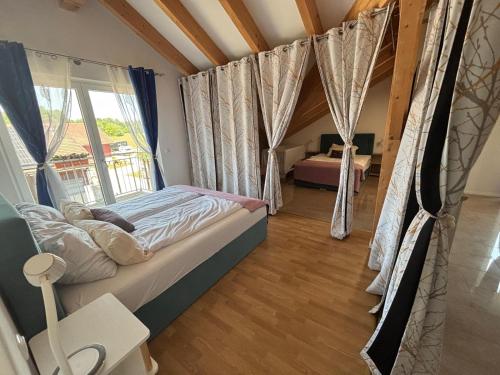 a bedroom with a bed and a window at HotelPension Weberhof in Ebersberg