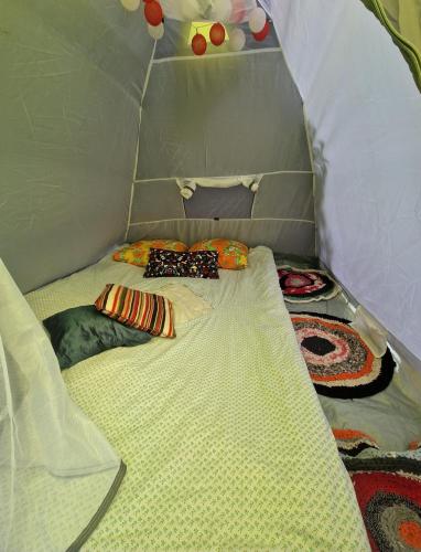 a small room with two ties on a bed at Tentu Tentu, Babushtent in Ventspils