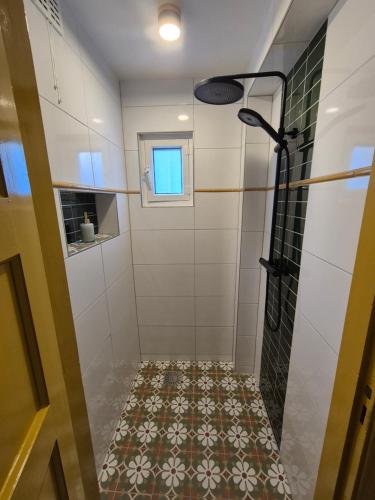 a bathroom with a shower and a tile floor at Morgenstond in Groesbeek
