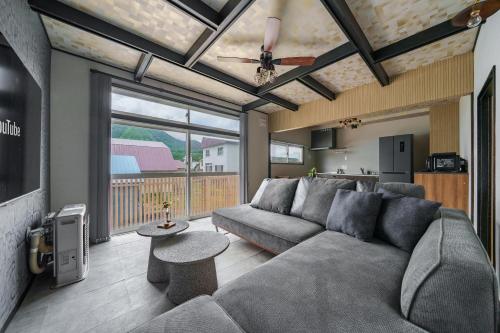 a living room with a couch and a table at Rusutsu Backcountry Lodge in Kimobetsu