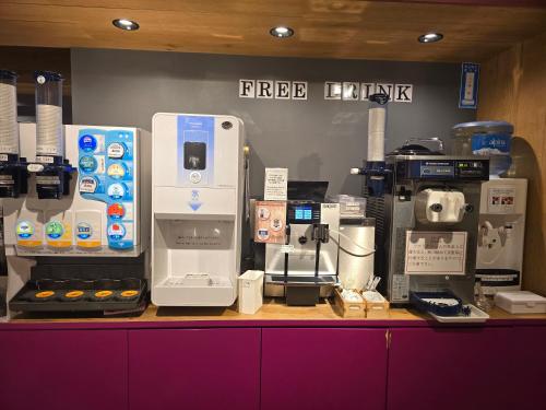 a coffee shop with a coffee machine on a counter at Booth Netcafe & Capsule in Tokyo
