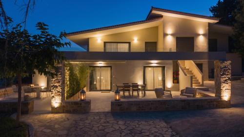 a house with a patio at night with lights at Casa di Mare in Kyparissia