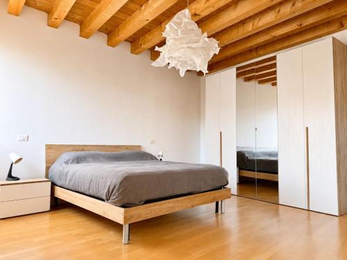 a bedroom with a bed and a mirror at Appartamento Donà 2 in Rovigo