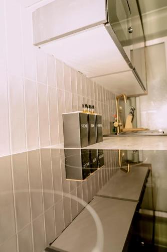 a kitchen with a sink and a mirror at The Whitehouse - Flat B in Carbis Bay