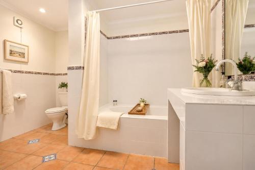 a white bathroom with a sink and a toilet at Constantia The Silos in Sweet Valley
