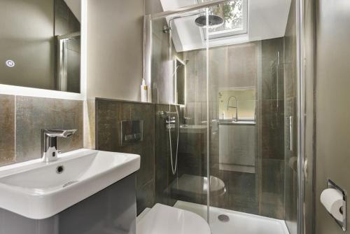 a bathroom with a glass shower and a sink at The Cosy Cottage - Ridgestone in Bowness-on-Windermere