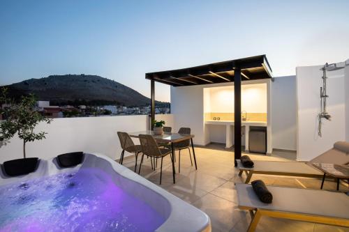 a bathroom with a bath tub on a balcony at ARCH Luxury Suites in Archangelos