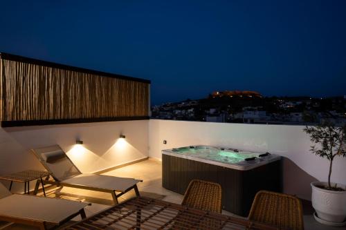 a hot tub on the roof of a building at ARCH Luxury Suites in Archangelos