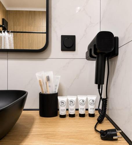 a bathroom with a microphone and cups on a counter at Гостиница Балхаш in Balqash