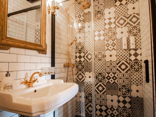 a bathroom with a sink and a shower at L'Ecrin des Roches in Le Langon