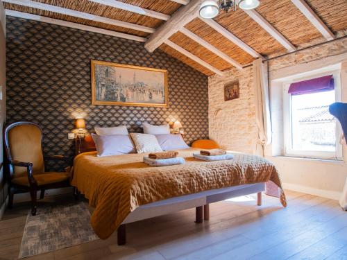 a bedroom with a bed with two towels on it at L'Ecrin des Roches in Le Langon