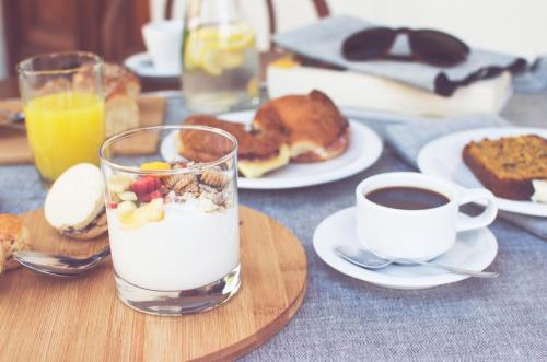 a table with a glass of milk and a cup of coffee at Dolores Hotel - Uruguay in Dolores