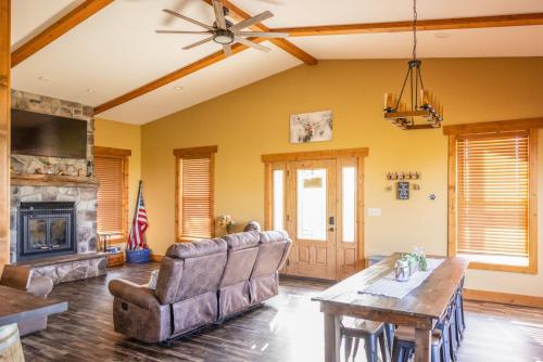 a living room with a couch and a fireplace at Tall Tine Lodge in La Prairie