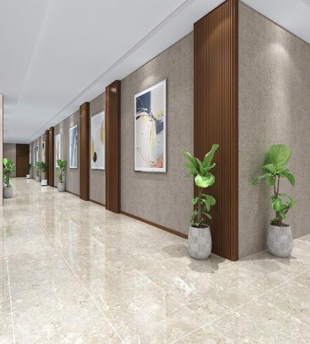 a hallway with potted plants in a building at Mayott By Vilaastaa in Indore