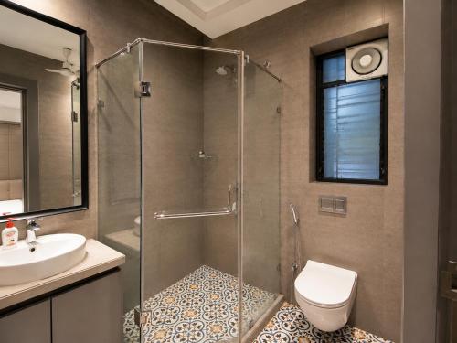a bathroom with a shower and a toilet and a sink at The Bay Suites - Salt Lake in kolkata