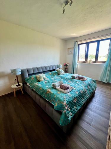 a bedroom with a bed with a quilt on it at The Sanctuary with private Jacuzzi in České Budějovice