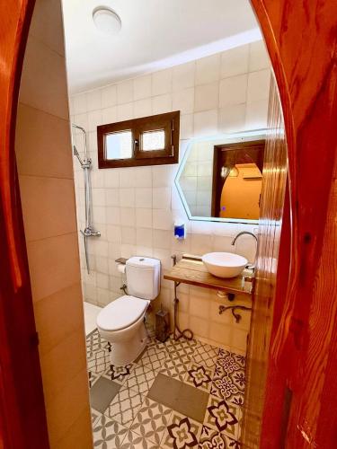 a bathroom with a toilet and a sink at Diyar Marhaba in Chefchaouen