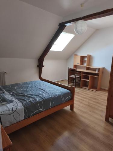 a bedroom with a bed in a room with a window at Gîte Mouchel in Le Vrétot