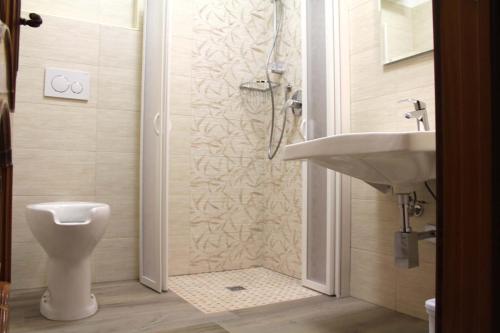 a bathroom with a shower and a sink and a toilet at Villa Bice in Pulsano