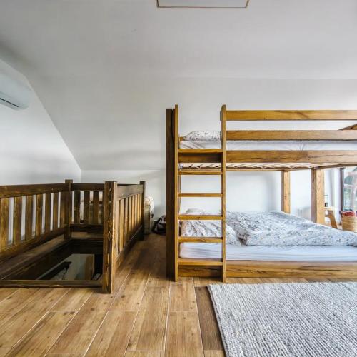 a bedroom with two bunk beds and a ladder at Chata na samote in Revúca