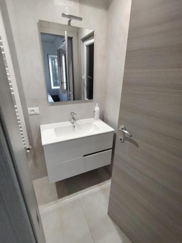 a bathroom with a white sink and a mirror at Affittacamere Torresi in Ancona