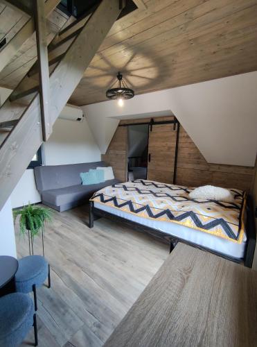 a large bedroom with a bed and a couch at Chata Bosorečka in Smižany