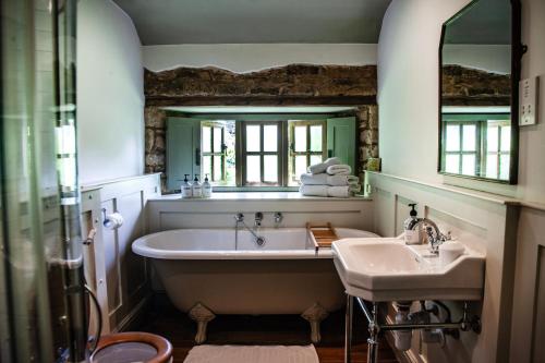 a bathroom with a tub and a sink at The Ebrington Arms in Chipping Campden