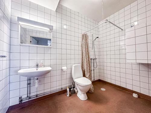 a bathroom with a toilet and a sink at Nässjö Vandrarhem in Nässjö
