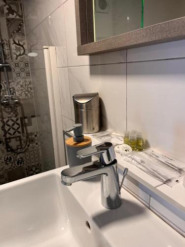 a sink with a faucet in a bathroom at Villa GoldenPearl in Povile