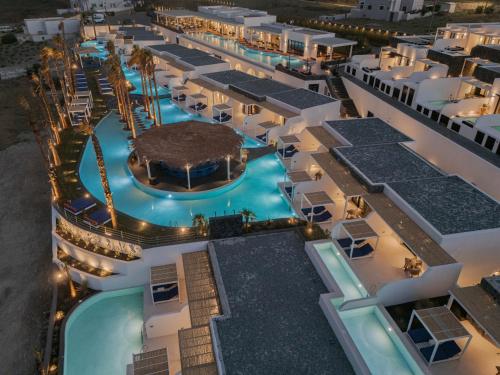 an aerial view of a hotel pool at night at Cresanto Luxury Suites in Imerovigli