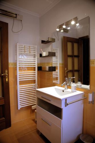a bathroom with a white sink and a mirror at La Placita in Caudiel