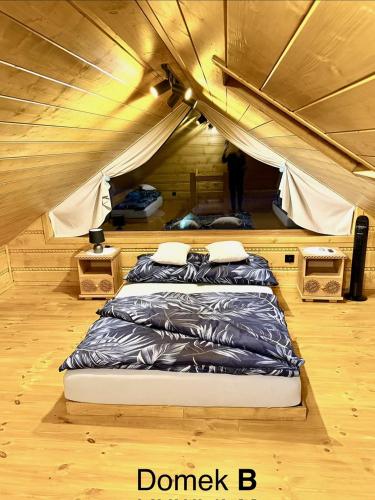 a bedroom with a bed in a tent at Pod Bieszczadzkim Niebem in Lutowiska