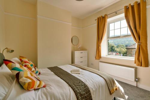 a bedroom with a bed and a window at Finest Retreats - 2 Haywood View in Grindleford Bridge