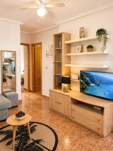 a living room with a large flat screen tv at Monte de Santa Pola in Gran Alacant