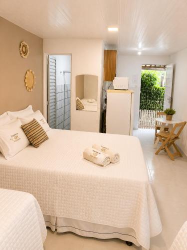 a bedroom with a bed with two towels on it at Pousada da Gih in Fernando de Noronha